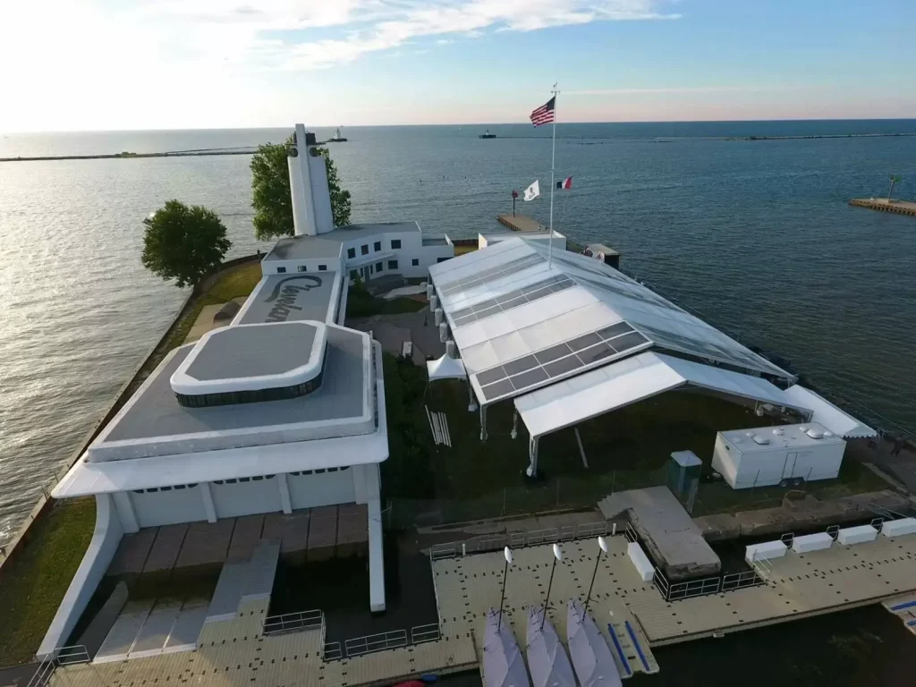 Large clear span canopy tent providing a shaded area by the lake.