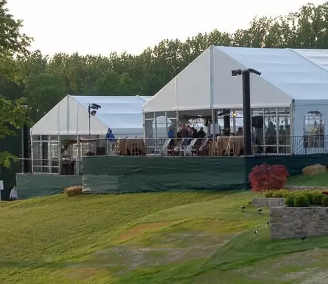 Clear span canopy tent with branding set up outdoors for a promotional event.