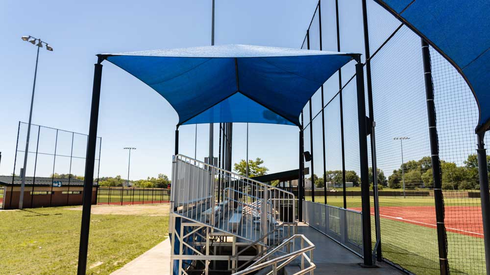 Anchor Industries bleacher canopies providing year-round spectator comfort at sports venues.