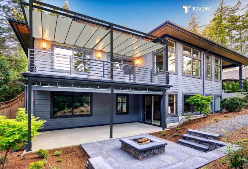 Modern retractable pergola installed on a stylish home, providing shade and comfort for outdoor living. High-quality residential patio covering solution.
