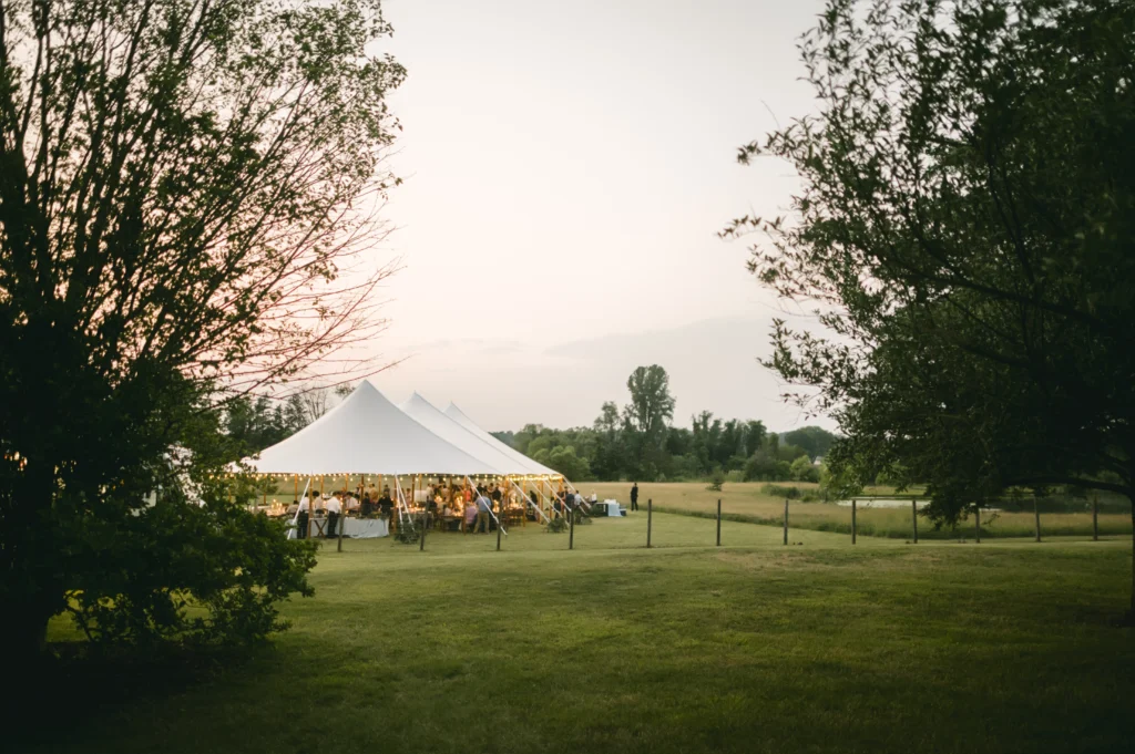 White pole tent by Anchor Industries in countryside outdoor venue