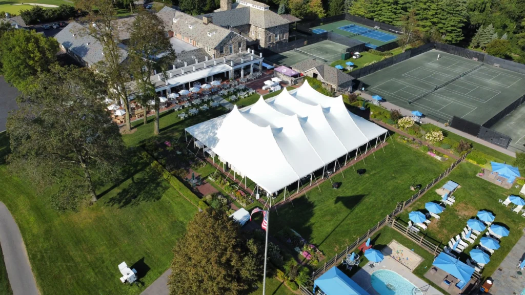 Multiple connected white pole tents at luxury event venue by Anchor Industries
