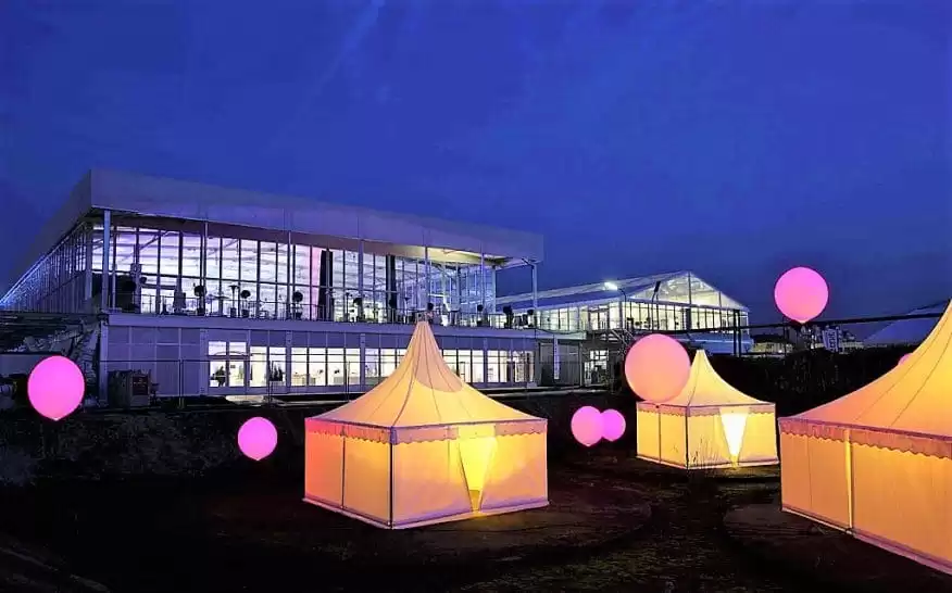 Illuminated high peak tents at night Anchor Industries installation