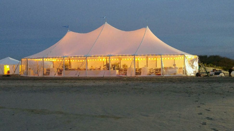 Large illuminated pole tent at night Anchor Industries event setup