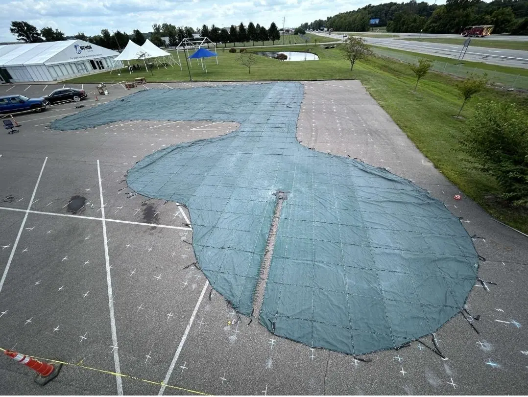 Large custom green safety pool cover Anchor Industries installation