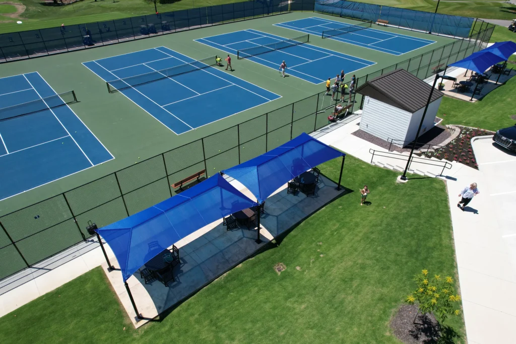 Anchor Industries blue shade canopies installed at tennis courts