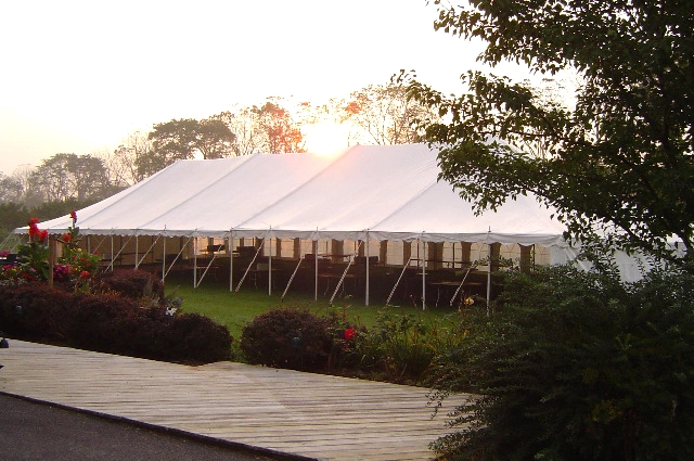 Large pole tent installation at outdoor event by Anchor Industries
