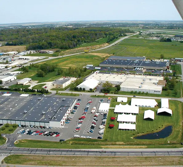 Aerial view of an industrial complex with multiple large white tents and buildings.