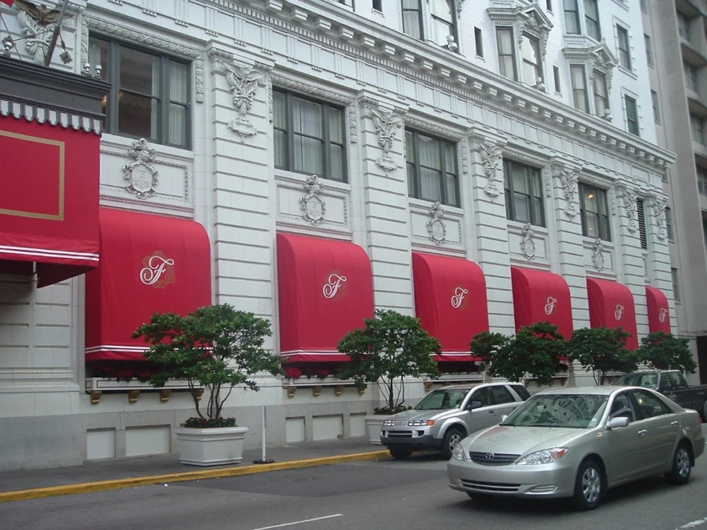Red arched window awnings on historic building Anchor Industries