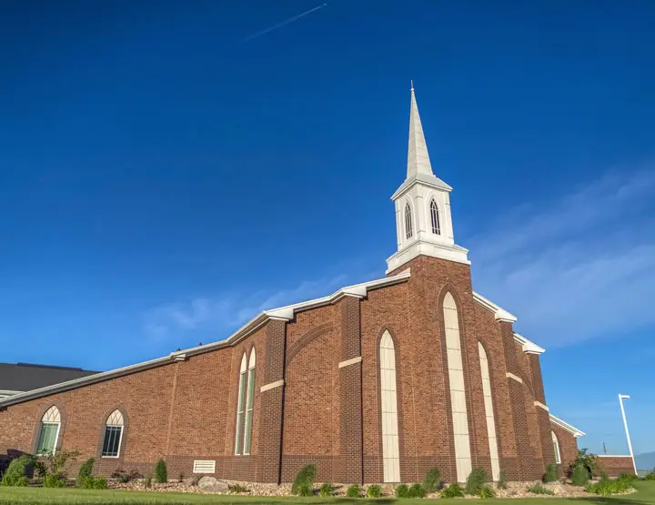 Church building with Anchor Industries event tent on lawn
