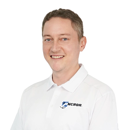 Portrait of Anchor Industries male employee in branded shirt