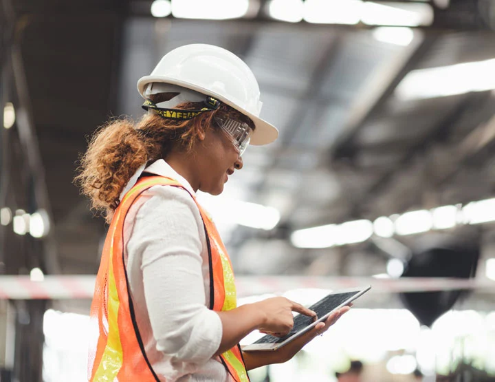 Anchor Industries construction worker reviewing project plans onsite