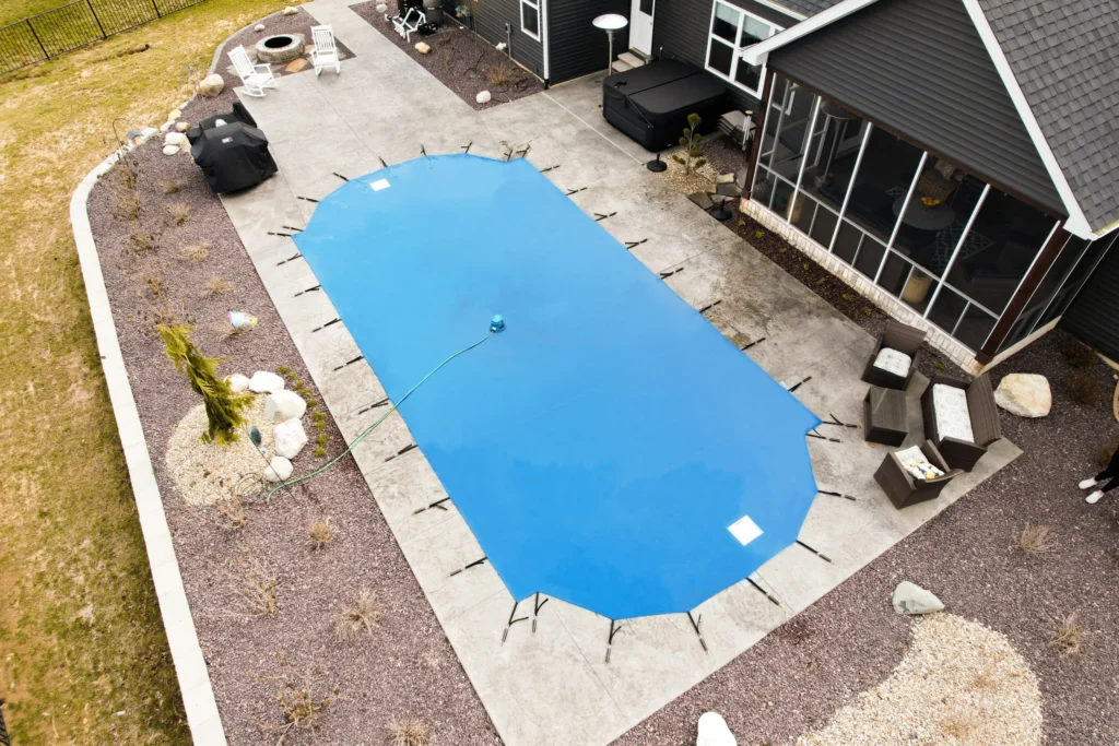 Bright blue pool cover protecting inground swimming pool at home