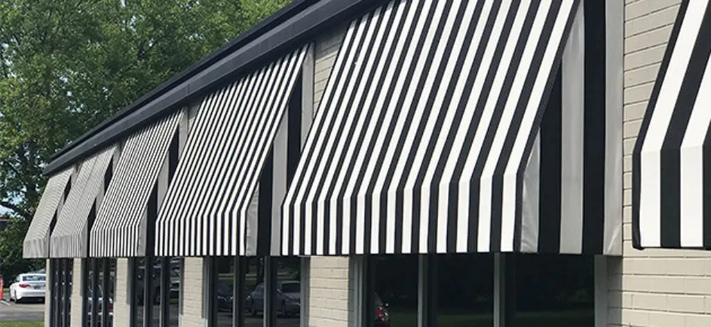 Office complex with striped black-and-white awnings along the windows.