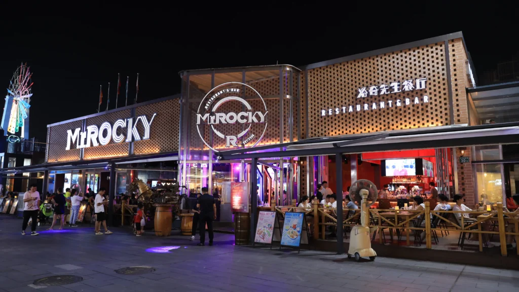 Commercial louvered pergola roof installed over packed restaurant outdoor seating to increase peak revenue.