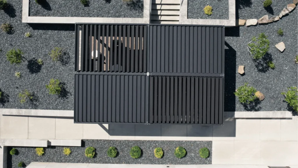 The largest louvered pergola by Anchor PERGOLAM shading a spacious luxury home patio setup.The largest louvered pergola by Anchor PERGOLAM shading a spacious luxury home patio setup.