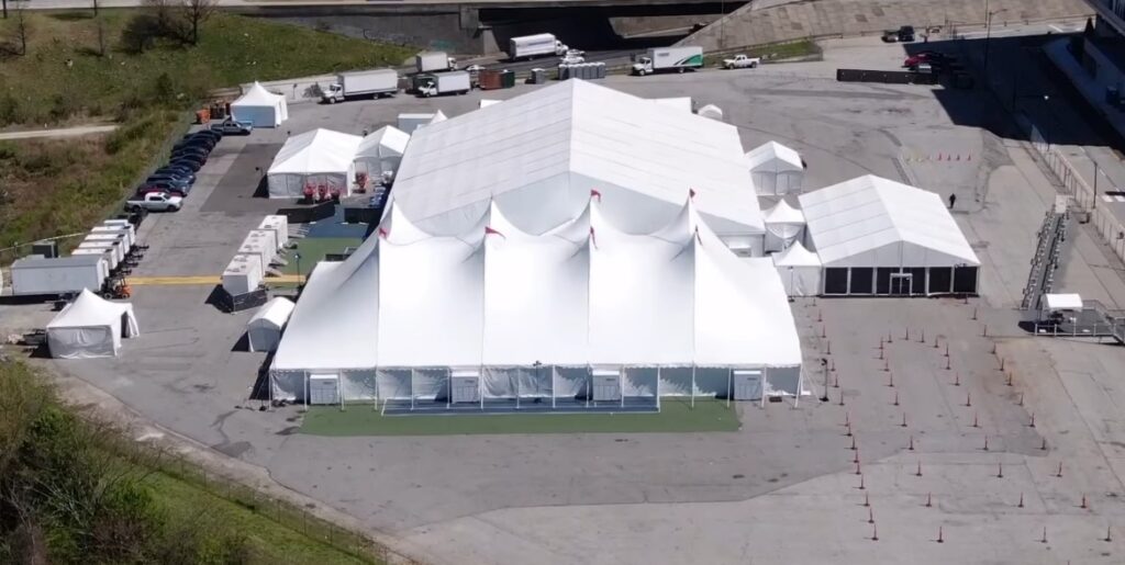 Rental company replacing a worn tent top with new fabric from Anchor Industries before the next event season.