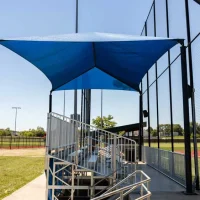Anchor Industries bleacher canopies providing year-round spectator comfort at sports venues.