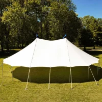 White pole tent set up on a grassy field for an outdoor gathering.